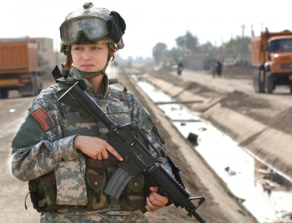 Pfc. Janelle Zalkovsky of the Civil Affairs Unit, 1st Battalion, 320th Field Artillery Regiment, 101st Airborne provides security while other Soldiers survey a newly constructed road in Ibriam Jaffes, Iraq, Dec. 4, 2005. The road project was initiated by the Civil Affairs Unit and cooperation with local officials to provide better access to the village from other main travel routes.(U.S. Army photo by Spc. Charles W. Gill) (Released)